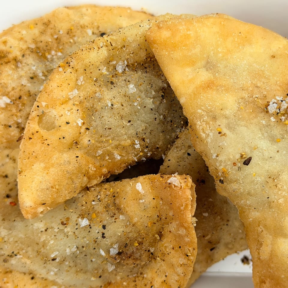 Close-up of golden-brown fried dough with visible salt and seasoning, likely from Little Bear Street Eats.